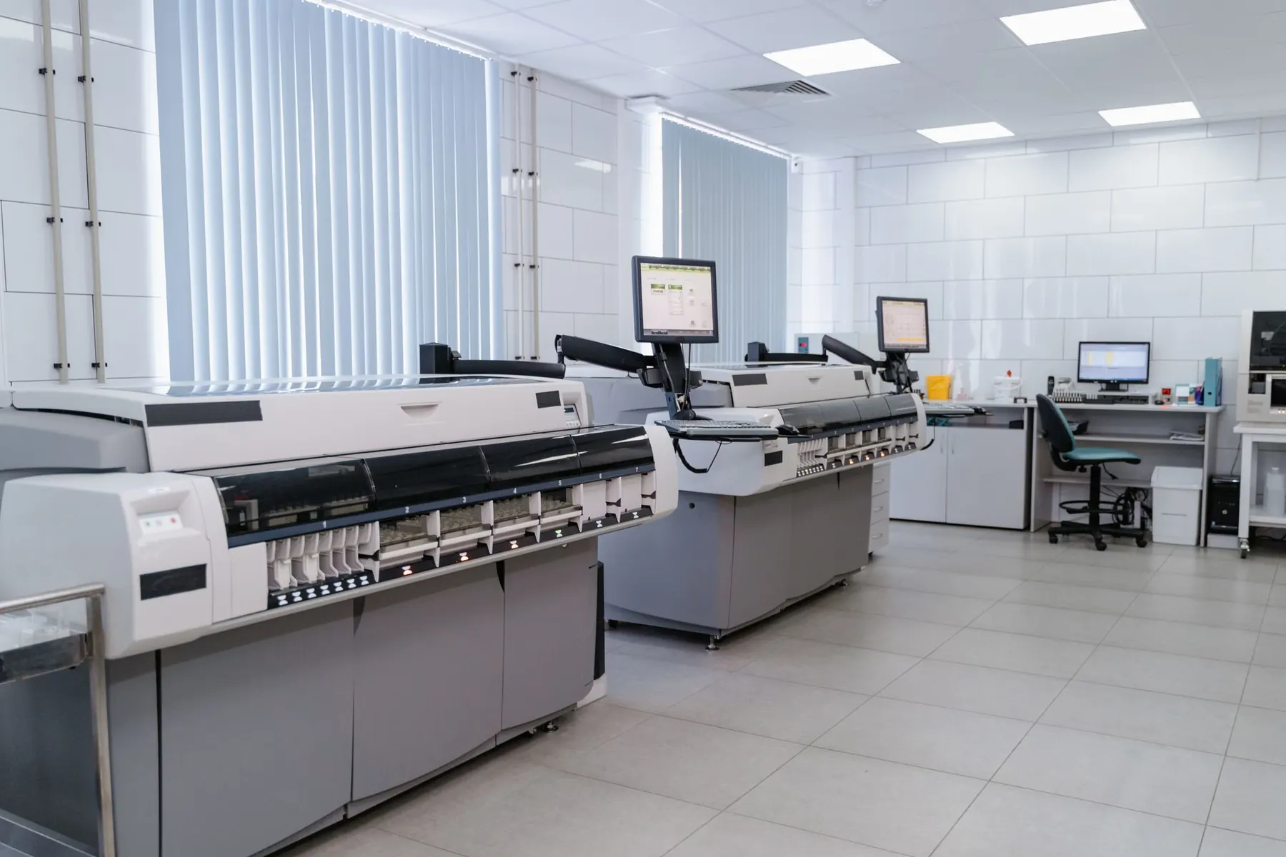 Clean print room with wide-format printers and computer workstations